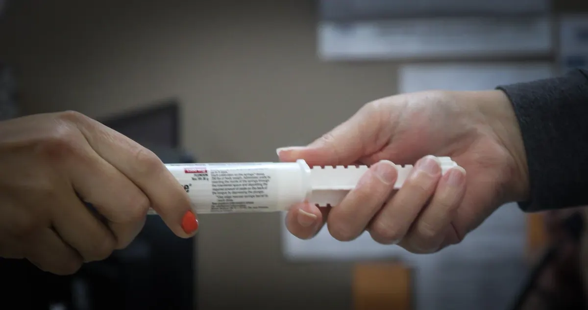 Oral paste medication being handed over